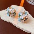 Macro shot of floral cluster stud earrings with pink blue petals and amber rhinestones - Blue Flower Cluster (Silver Pin)