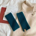 Pair of dark blue knitted arm warmers with ribbed texture and brown leather label - Straight-Peacock Blue