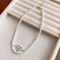 Detailed view of an elegant vintage pearl necklace displayed on a beige jewelry tray - Necklace Style 38 / 6mm Pearl / Gold-White