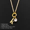 Stainless steel gold necklace with a letter K pendant and a sparkly round crystal - Letter K (XNL0103)