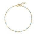 Detailed view of a gold-plated link bracelet featuring light blue circular beads and lobster clasp - Bracelet / Light Blue