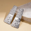 Macro shot of silver geometric square earrings with hammered texture on stone background - Silver (925 Sterling Silver Earring Post) / Silver