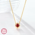 Macro shot of 925 sterling silver necklace featuring a red zircon pendant with white stones - 925 Silver / Gold Red