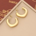 Detail of golden U-shaped geometric metal earrings on beige leather texture display - Thickened U-Shape Style (5#)