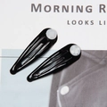 Pair of black teardrop BB hair clips with triple cutout design and white round accents - Black