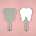 Cute tooth-shaped hand mirror in grey plastic finish with ergonomic handle and hanging hole - Light Green