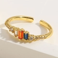 Macro shot of gold adjustable ring featuring emerald-cut blue, orange, and white zircon - Adjustable Open / Rectangular Multicolor Zirconia