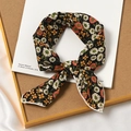 Elegant black floral cotton linen scarf with colorful flower patterns on a white book - Hibiscus Black Base
