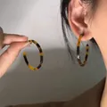 Close-up of tortoise shell pattern acrylic C-shaped hoop earrings worn on ear - Tortoise (24# Silver Pin)