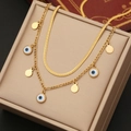 Double-layered gold necklace featuring evil eye pendant on a sleek snake chain and link chain - Flat Disc