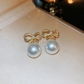 Elegant gold bow earrings with white round pearl drop on a beige jewelry display - 14# Silver Earring Post - Gold (Bowknot Pearl)
