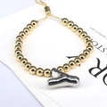 Macro view of gold beaded bracelet with adjustable cord and silver letter Y pendant - Letter Y