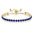 Adjustable gold plated tennis bracelet with 4mm round-cut deep blue cubic zirconia stones - Light Gold + Sapphire Blue Zirconia