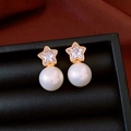 Close-up of 18K gold-plated star pearl earrings in a black velvet jewelry box - Gold-White