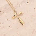 Detailed shot of 18K gold cross pendant with colorful zircon stones on stone surface - Multi-color Rectangular Stone Twisted Cross (2#)
