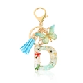 Letter D crystal resin keychain with green dried flowers, blue tassel and butterfly charm - Letter D