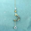 Golden sun and moon crystal suncatcher with colorful mineral stones and faceted prism ball - Fluorite