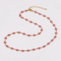 Golden necklace featuring small pink sparkling oil-drip hearts with lobster clasp closure - Pink
