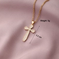 Macro detail of gold cross pendant with cubic zirconia, weighing 5g and 3.2cm in height - Cross 11