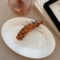 Franse vintage banaan haarklem met luipaardprint in amber voor een chique stijl - Oranjebruin