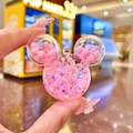 Detail of pink liquid glitter Mickey-shaped keychain with stars and beads in hand - Luminous Bubble Bead Mickey Head / 1 Piece (Without Keychain) / Pink