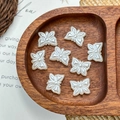 Detail of white butterfly pearl acrylic beads for DIY necklace jewelry making on a tray - White Butterfly