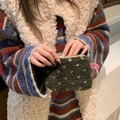 Close-up of plush dark green polka dot storage bag with soft lamb wool texture - Lamb Wool Heart Green
