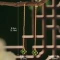 Macro view of green clover earrings on a branch with dimensions 8.0cm by 0.95cm - Green Clover Ear Thread (GF0087)