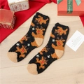Detail of soft coral fleece Christmas socks featuring brown reindeer and snowflakes - Black Reindeer