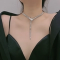 Punk style silver snake-shaped necklace with detailed head and tail on female model - Silver Necklace Style