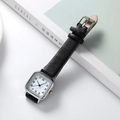 Detail of square quartz watch with black leather strap on minimalist magazine background - Black Strap White Dial