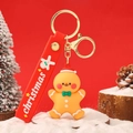 Cute gingerbread man Christmas keychain with red hat and green bowtie on red background - Festive Christmas Gingerbread Man