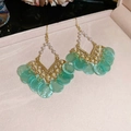 Detail of flower earrings with green shell inlays and white pearls on beige velvet - Green Shell Fan Shape (Ear Hook)