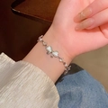 Elegant silver bow bracelet with opalescent stones and pearls on woman's wrist - S616 Silver B - Bow Bracelet