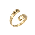 Detail of gold open ring featuring engraved LOVE text and a cutout cross element - Love Cross / Gold