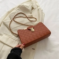 Brown woven rectangular shoulder bag with gold clasp and elegant chain strap details - Brown