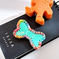 Gingerbread man hair clip in orange with green bone tag and cute colorful yarn detail - Bone-Cyan