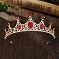 Detail of vintage gold crown with red gems and sparkling rhinestones on wood - Gold Red Zirconia