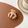 Close-up of a matte nude pink small hair claw clip on a brown leather desk mat - Matte Coffee (Large Approx. 5cm)