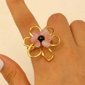 Exaggerated golden floral ring with pink raw stones and black bead on finger - Gold (X403)