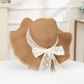 Detail of woven straw texture and large white lace bow on brown summer sun hat - Plum Wave Khaki