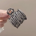 Detail of dark grey metal hair claw clip with abstract coiled lines for high ponytail - Mineral Grey