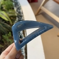Detail of a 10cm blue triangular hollow hair claw clip with a glossy finish - Haze Blue