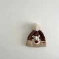 Detail of baby winter knit hat with 3D reindeer pattern and soft white fluffy pompom - Hat / Brown