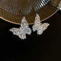 Macro detail of silver butterfly earrings encrusted with sparkling clear zircon crystals - Full Diamond Butterfly Teardrop Stud Earrings
