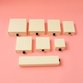 Beige drawer-style jewelry boxes in various sizes with black ribbon pulls on pink base - 21x4.5x3.5cm / Off White