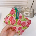 Close-up of pink tulip floral cotton pouch with green knot zipper and side brand tag - Rose Red Tulip