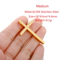 Handheld view of a medium 304 stainless steel gold cross pendant with dimensions - Medium (43*26mm) / Gold