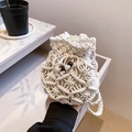 Detailed close-up of handmade cream cotton crochet mini bucket bag with wooden bead decor - Off White