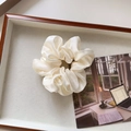 Detailed view of an off-white oversized satin scrunchie on a decorative tray - Medium / Off White